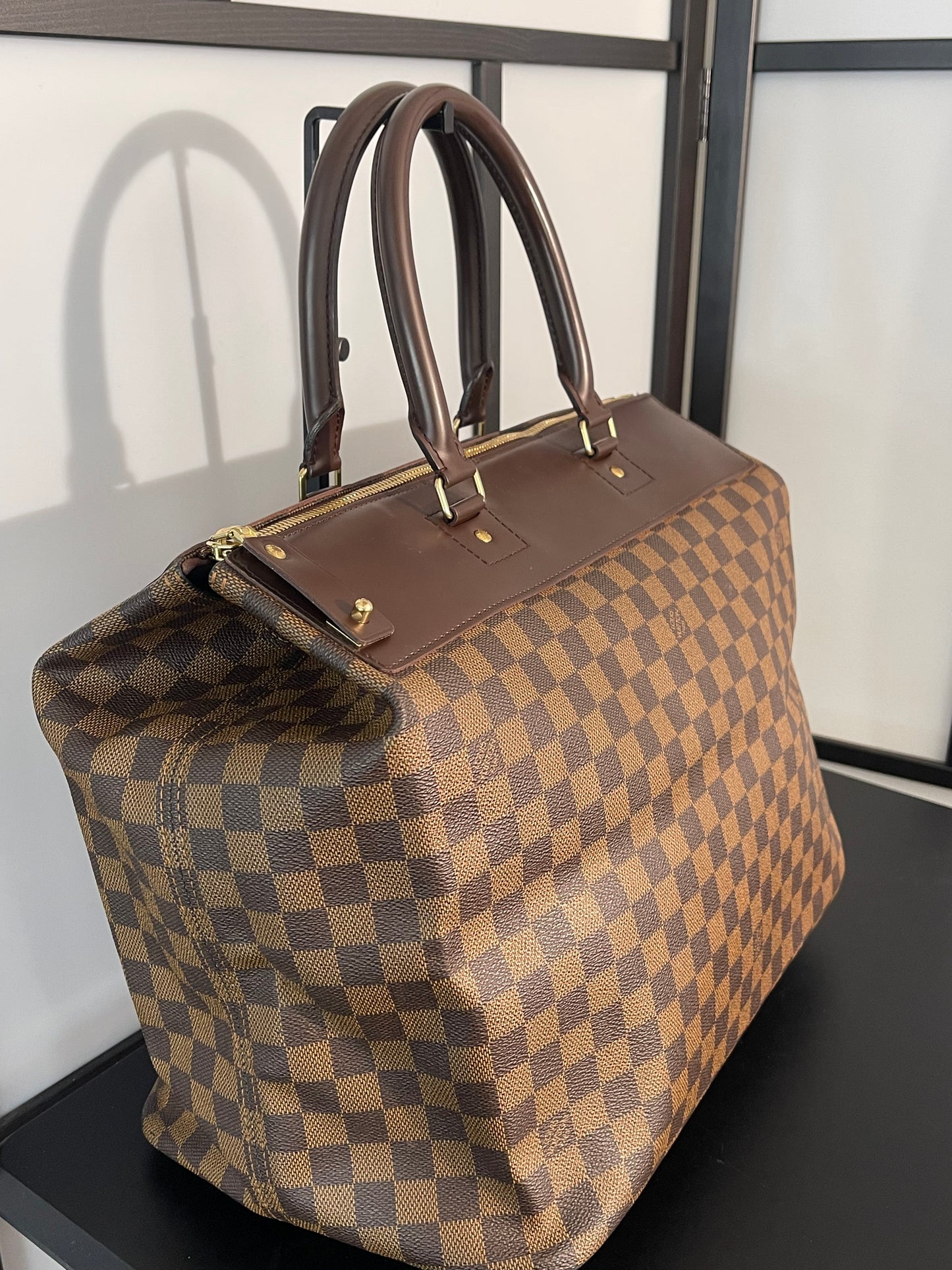 This is a pre-owned Louis Vuitton Brown Damier Ebene Greenwich Handbag/Travel Bag.