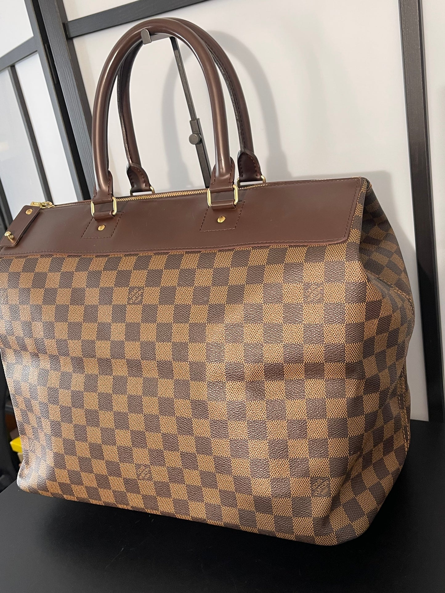 This is a pre-owned Louis Vuitton Brown Damier Ebene Greenwich Handbag/Travel Bag.
